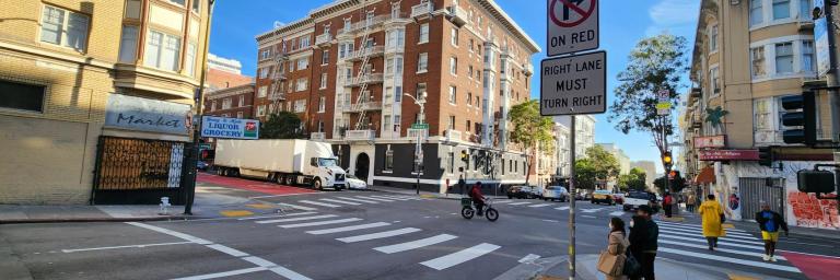 Hyde and Geary crosswalk safety treatments post implementation, advanced limit lines, crosswalk , no right turn on red sign 